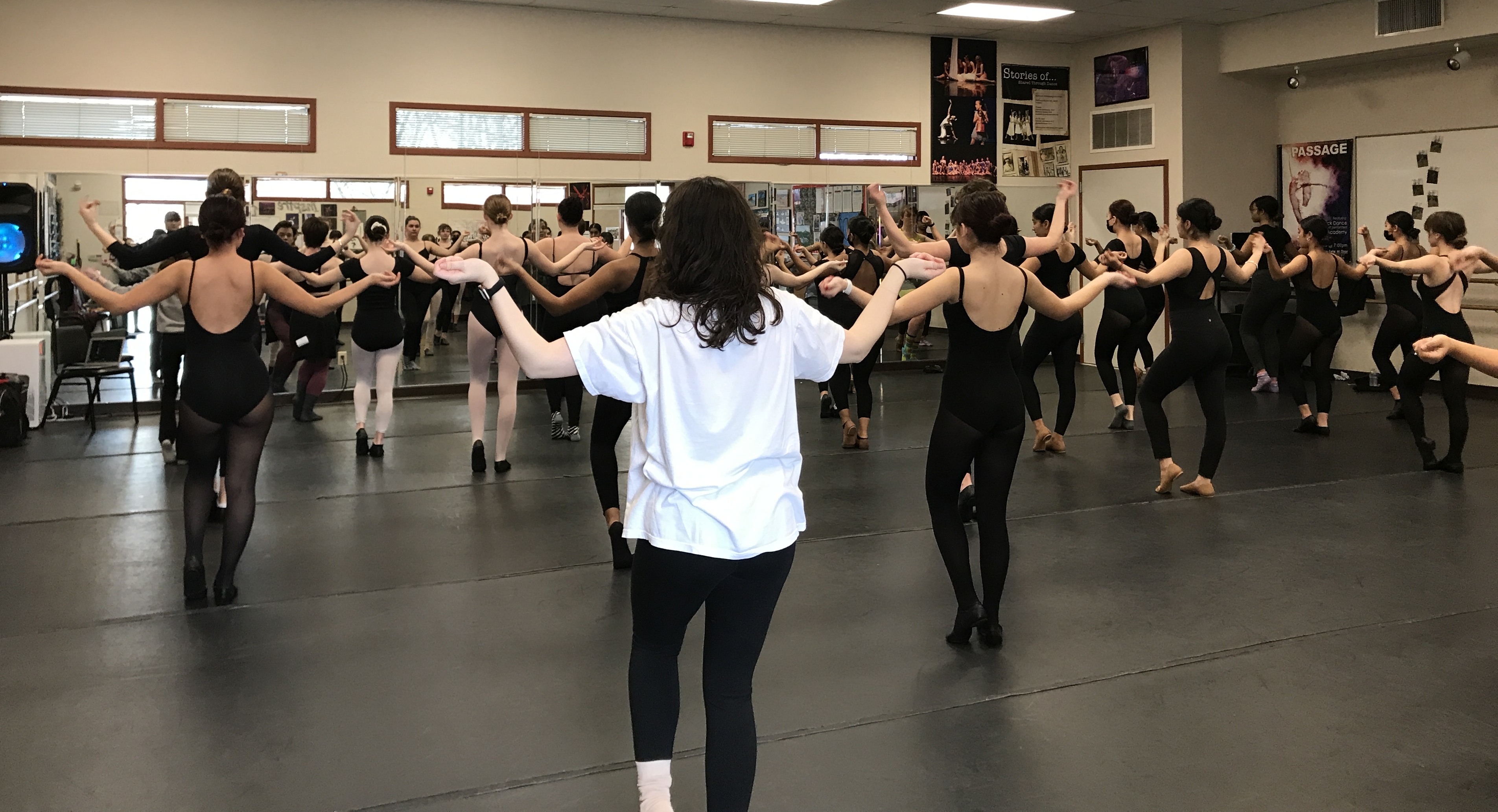 Cal Poly Students teaching students at Natomas Charter School a dance combination