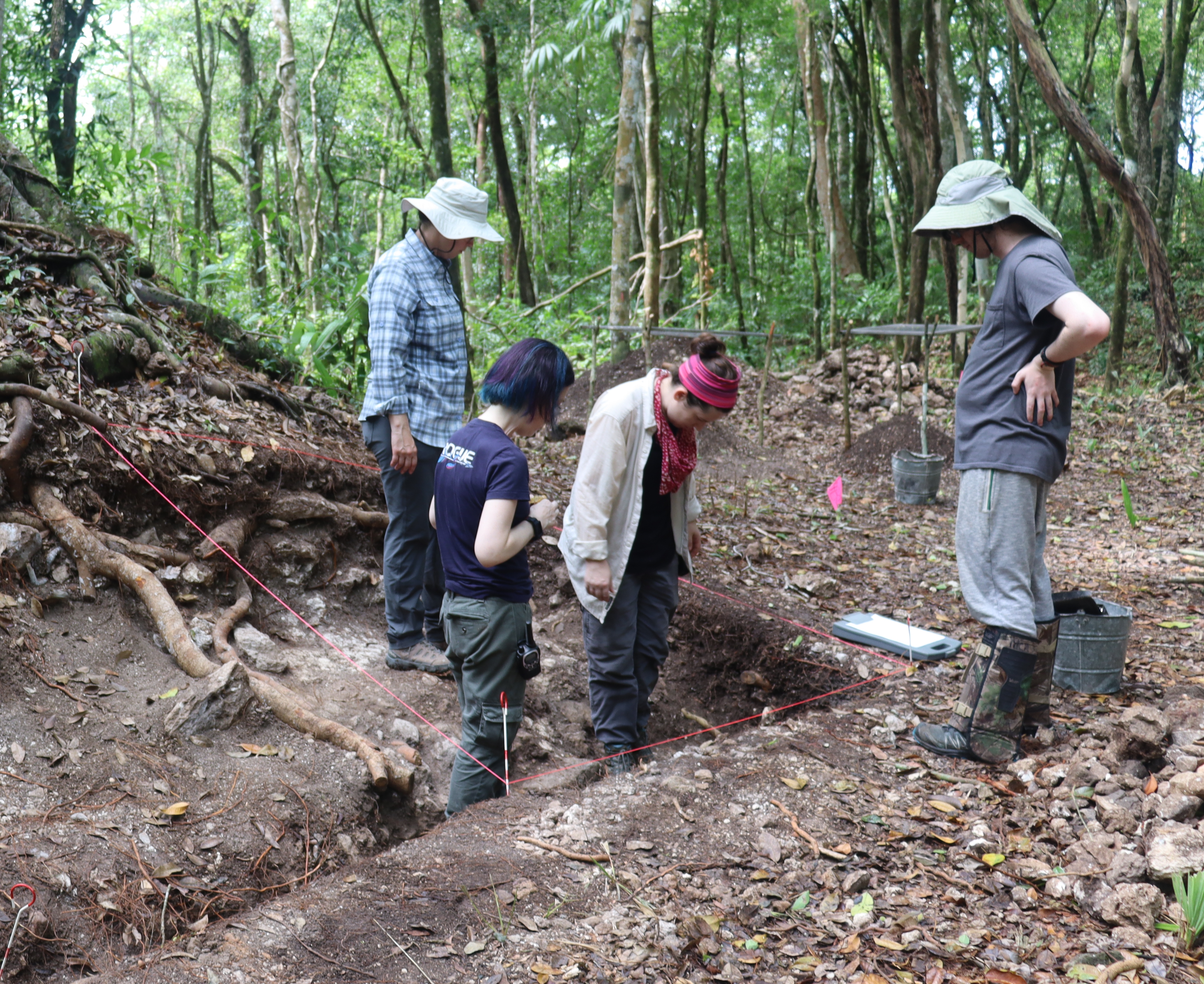 A photo of Dr. Marisol Cortes-Rincon with students excavating a Maya Temple Shrine in Belize. 